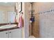 Tiled shower features a shower caddy with soap, shampoo and conditioner at 721 Dania Ct, Punta Gorda, FL 33950