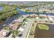 Stunning aerial view of waterfront homes with lush landscaping and private docks on the canal at 8774 Mystic Cir, North Port, FL 34287