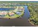 Picturesque aerial perspective of waterfront homes with pools and boat docks by a winding canal at 8774 Mystic Cir, North Port, FL 34287