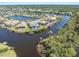 Overhead view of luxurious homes lining the waterfront, featuring private pools and boat access at 8774 Mystic Cir, North Port, FL 34287