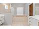 Bright bathroom featuring a glass-enclosed shower and soaking tub beneath a window at 8774 Mystic Cir, North Port, FL 34287