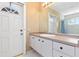 Quaint bathroom featuring a vanity and sink and patterned wallpaper at 8774 Mystic Cir, North Port, FL 34287