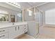 Bathroom featuring double sinks with sleek white cabinetry, shower and soaking tub at 8774 Mystic Cir, North Port, FL 34287