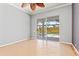 Bedroom with tan tile flooring, ceiling fan and sliding glass door to pool at 8774 Mystic Cir, North Port, FL 34287