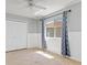 Bright bedroom with a ceiling fan, a window with curtains, and a closet with double doors at 8774 Mystic Cir, North Port, FL 34287
