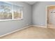 Bedroom featuring a large window, plush carpet and neutral decor, perfect for relaxation at 8774 Mystic Cir, North Port, FL 34287