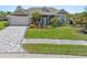 Well-maintained home with a lush garden, paved driveway, and a welcoming, landscaped front yard at 8774 Mystic Cir, North Port, FL 34287