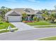 Charming single-story home with a well-manicured lawn, vibrant flowerbeds, and a spacious driveway at 8774 Mystic Cir, North Port, FL 34287