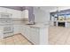 Bright kitchen with white cabinetry, island, and open layout at 8774 Mystic Cir, North Port, FL 34287