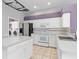 Bright kitchen features white cabinets, stainless steel appliances, and a functional island at 8774 Mystic Cir, North Port, FL 34287