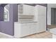 Kitchen boasts white cabinets and drawers with adjacent countertop at 8774 Mystic Cir, North Port, FL 34287
