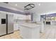 Kitchen with white cabinetry, stainless appliances, and island at 8774 Mystic Cir, North Port, FL 34287