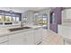 Kitchen featuring white cabinets, tile flooring, and an open layout to living area at 8774 Mystic Cir, North Port, FL 34287
