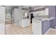 Kitchen boasts white cabinets, center island, and stainless steel appliances at 8774 Mystic Cir, North Port, FL 34287