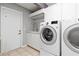 Convenient laundry area with modern washer and dryer units, sink, and ample cabinet space at 8774 Mystic Cir, North Port, FL 34287