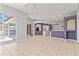 Open-concept living area with easy access to the kitchen and outdoor screened lanai at 8774 Mystic Cir, North Port, FL 34287