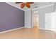 Neutral main bedroom with ceiling fan and access to the en suite bathroom and walk-in closets at 8774 Mystic Cir, North Port, FL 34287