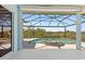 This shot showcases the screened lanai and pool, offering a view of lush greenery at 8774 Mystic Cir, North Port, FL 34287