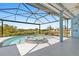 Sparkling pool and spa under a screened lanai with view of nature at 8774 Mystic Cir, North Port, FL 34287