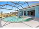 Relaxing screened-in pool and spa with beautiful landscaping view at 8774 Mystic Cir, North Port, FL 34287