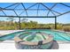 Inviting covered pool and hot tub, offering a relaxing outdoor experience with beautiful views at 8774 Mystic Cir, North Port, FL 34287