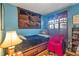 Cozy bedroom features unique tapestry wall art and comfortable furnishings at 1060 Venetian Pkwy, Venice, FL 34285