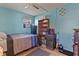 Comfortable bedroom with a mini-fridge, bed, and window at 1060 Venetian Pkwy, Venice, FL 34285