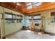 Bright sunroom features tiled floors and a collection of plants at 1060 Venetian Pkwy, Venice, FL 34285