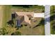 Bird's eye view of house, roof, driveway, screened lanai, and landscaping at 121 Long Meadow Ln, Rotonda West, FL 33947