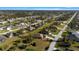Overhead drone shot of the neighborhood showcasing homes, lawns and surrounding streets at 121 Long Meadow Ln, Rotonda West, FL 33947