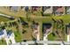 Aerial view of the home showcasing the roof, driveway and surrounding landscaping at 121 Long Meadow Ln, Rotonda West, FL 33947