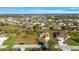 Aerial shot of neighborhood featuring the house, surrounded by other homes and trees at 121 Long Meadow Ln, Rotonda West, FL 33947