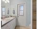 Bathroom features a vanity with plenty of storage space and a door to the exterior at 121 Long Meadow Ln, Rotonda West, FL 33947