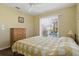 Comfortable bedroom with a queen bed and a view of the pool at 121 Long Meadow Ln, Rotonda West, FL 33947