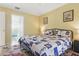 Comfortable bedroom with a queen bed and ensuite bath featuring calming blue and white accents at 121 Long Meadow Ln, Rotonda West, FL 33947