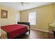 Inviting bedroom with a queen bed, neutral tones, and plenty of natural light at 121 Long Meadow Ln, Rotonda West, FL 33947