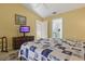 Bright bedroom boasts a TV, dresser, and ensuite bath, perfect for relaxing after a long day at 121 Long Meadow Ln, Rotonda West, FL 33947