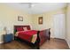 Comfortable bedroom featuring a queen bed, hardwood floors, and a spacious closet at 121 Long Meadow Ln, Rotonda West, FL 33947
