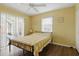 Bedroom with a queen bed, natural light, and a view of the pool at 121 Long Meadow Ln, Rotonda West, FL 33947