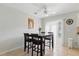 The dining area is well-lit with a ceiling fan and access to the outdoors at 121 Long Meadow Ln, Rotonda West, FL 33947
