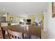Open-concept dining area, connecting to the living room and kitchen with bright, natural light at 121 Long Meadow Ln, Rotonda West, FL 33947
