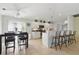 Bright kitchen features white cabinets, stainless appliances, breakfast bar, and an adjacent dining area at 121 Long Meadow Ln, Rotonda West, FL 33947