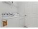 A practical laundry room with washer, dryer, and shelving for added storage at 121 Long Meadow Ln, Rotonda West, FL 33947
