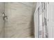 Shower features modern tile and a neutral color scheme at 121 Long Meadow Ln, Rotonda West, FL 33947