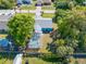 Aerial view of home with a screened-in pool and lush trees in the backyard at 1341 Preston St, Port Charlotte, FL 33952