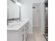 Bathroom featuring double sink vanity, modern fixtures, and access to a large closet at 1341 Preston St, Port Charlotte, FL 33952