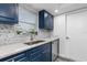 Close up of modern kitchen with updated cabinets, countertops, stainless steel appliances, and decorative backsplash at 1341 Preston St, Port Charlotte, FL 33952