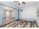 Sunroom with gray wood floors and sliding glass doors to living areas in the house at 1341 Preston St, Port Charlotte, FL 33952