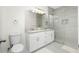 Modern bathroom boasts double sinks, granite countertops, and a tiled walk-in shower at 1384 Alpinia Rd, North Port, FL 34288