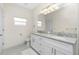 Well-lit bathroom features double sinks, granite countertops, and ample space at 1384 Alpinia Rd, North Port, FL 34288